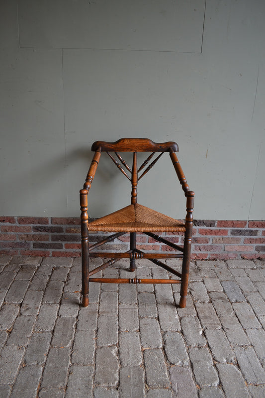 Antieke eiken houten driepoot stoel met biezen zitting en gedraaide poten. Antieke hoekstoel. antieke fauteuil, antieke eiken stoel.